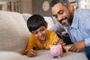 Man and child with piggy bank